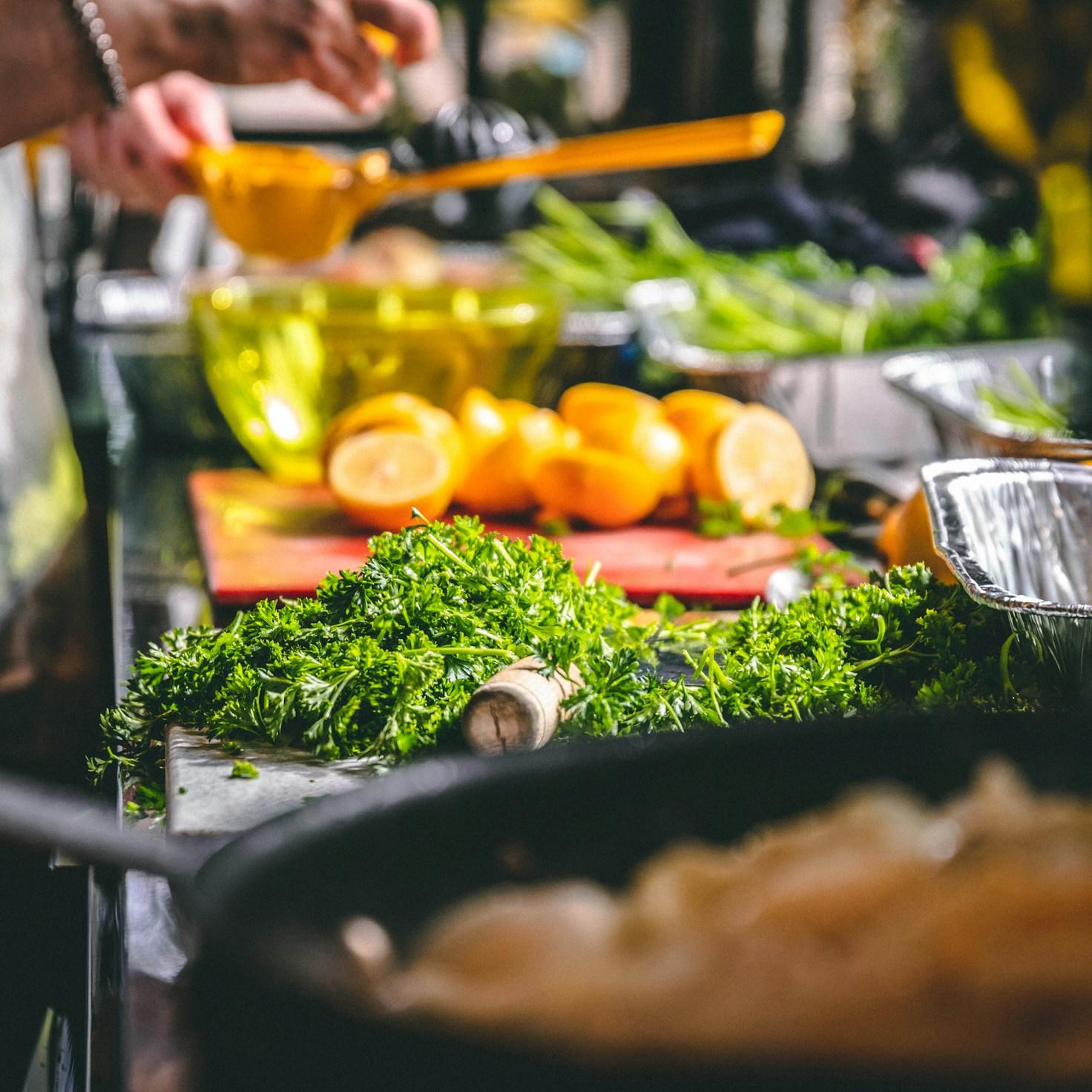 Diverse group of community members sharing a meal together, showcasing the social bonds formed through collaborative cooking